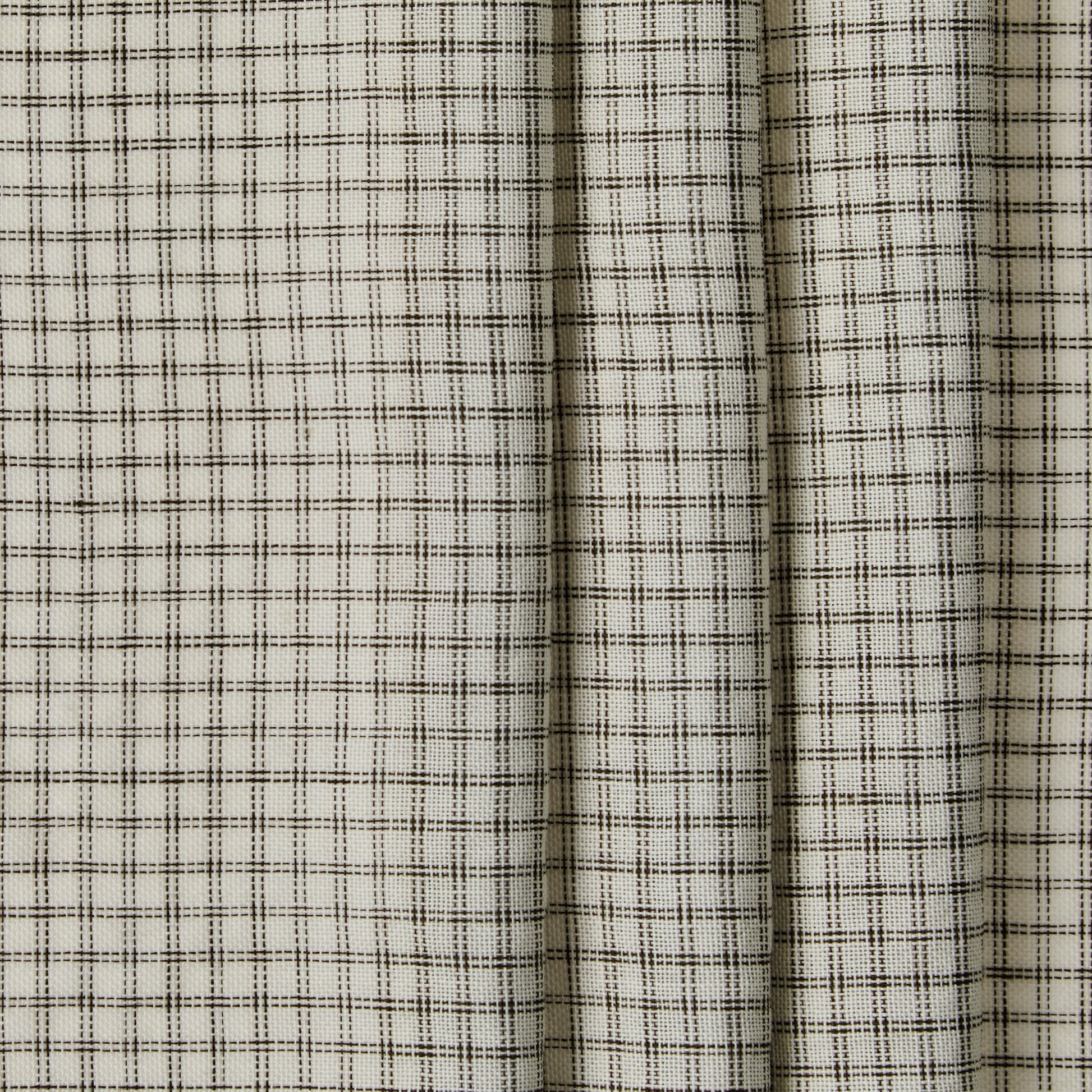 Close-up of a fabric with a subtle check pattern on a neutral background
