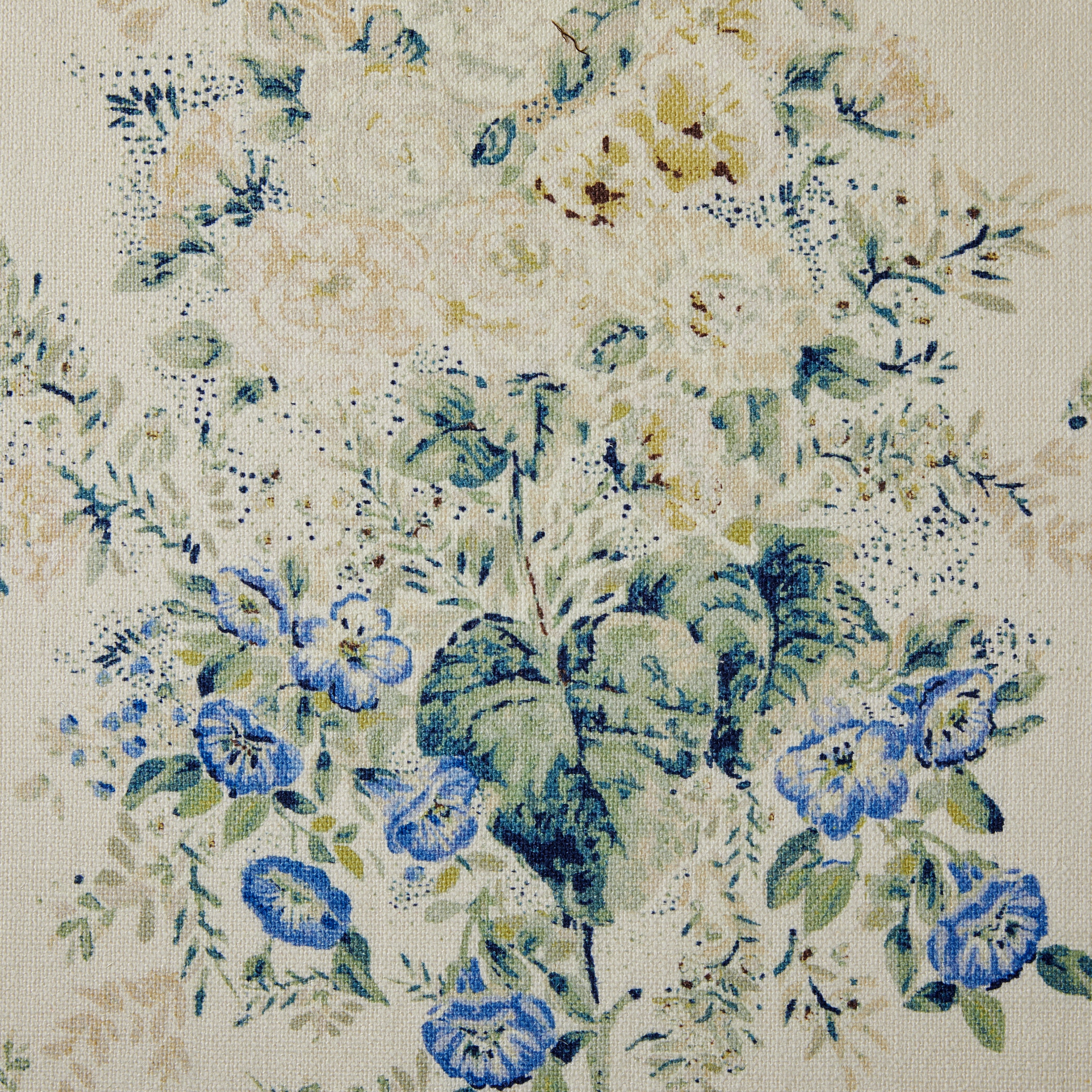 Floral patterned fabric with blue and green flowers on a beige background
